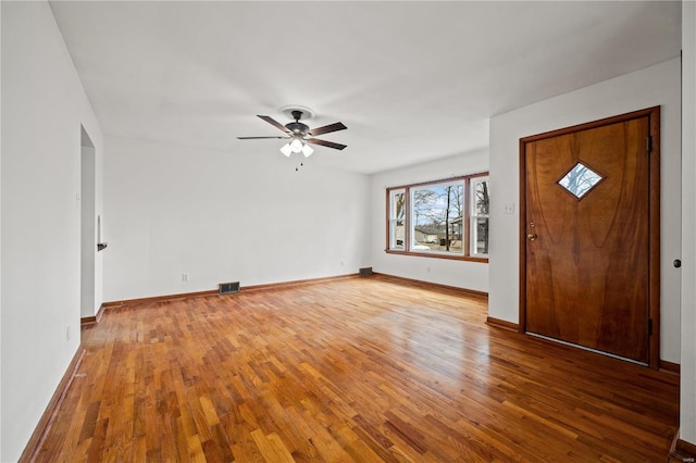 entrance foyer featuring wood-type flooring, visible vents, and baseboards