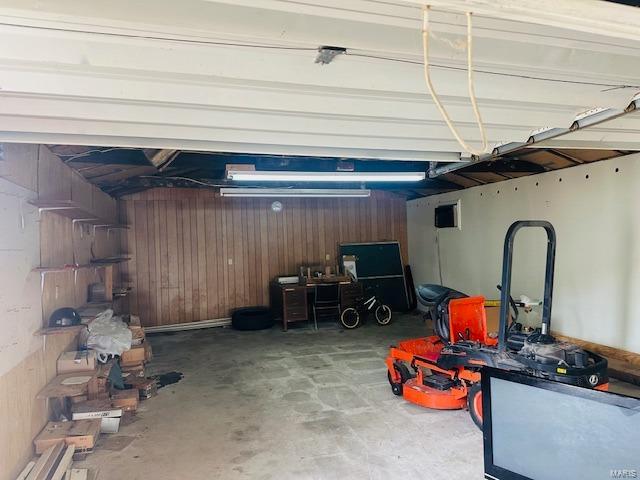 garage featuring wood walls