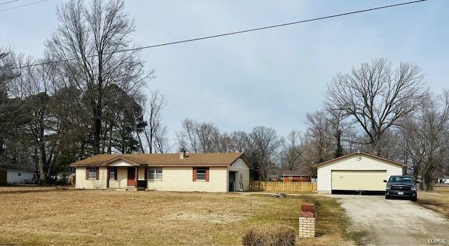 ranch-style house with an outdoor structure and a detached garage