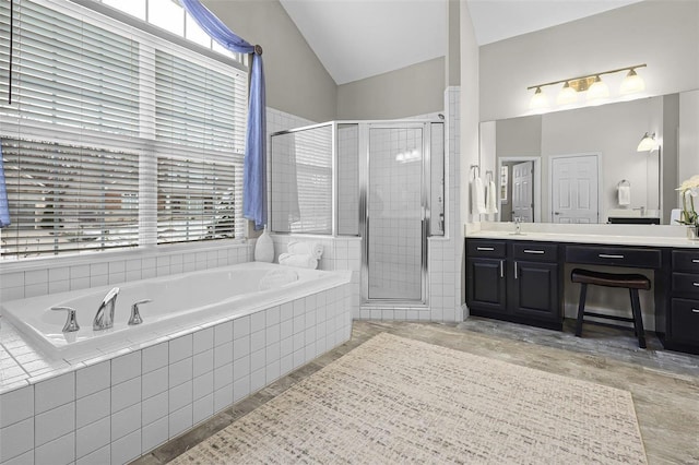 bathroom with a stall shower, plenty of natural light, vanity, and a bath