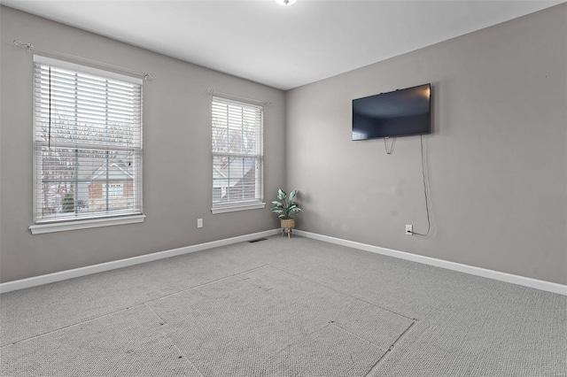 spare room with visible vents and baseboards