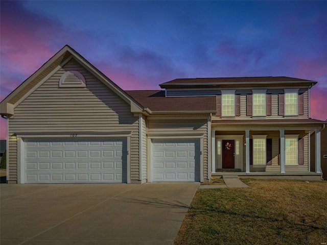 traditional-style home featuring a garage, a porch, concrete driveway, and a front yard