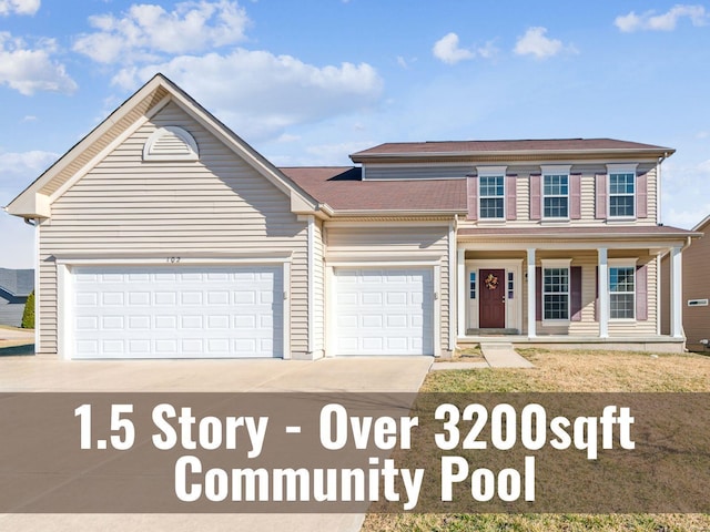 view of front of home with a garage, driveway, and covered porch