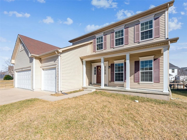 view of front of home featuring a garage, covered porch, driveway, and a front yard