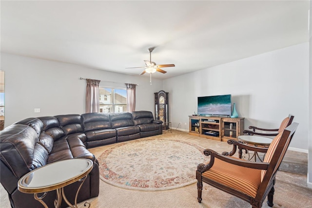 living area with ceiling fan, carpet flooring, and baseboards