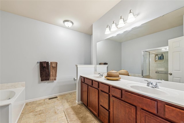 bathroom featuring double vanity, a sink, a bath, and a shower stall