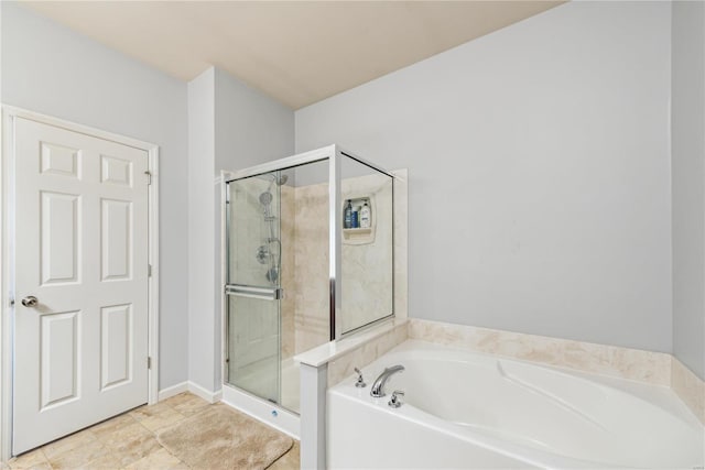 bathroom featuring a garden tub and a shower stall