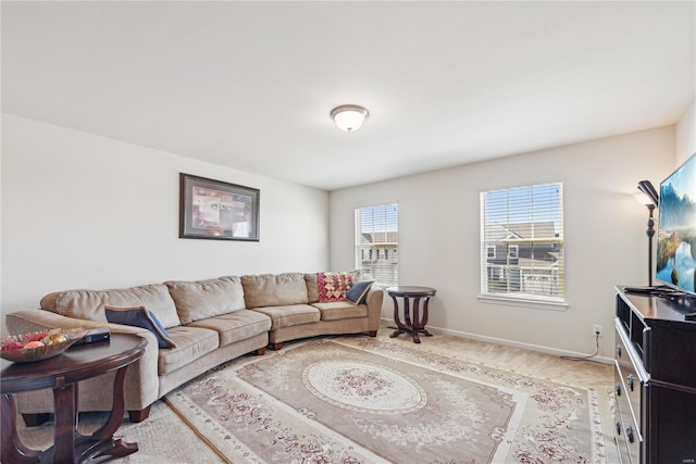 carpeted living area featuring baseboards