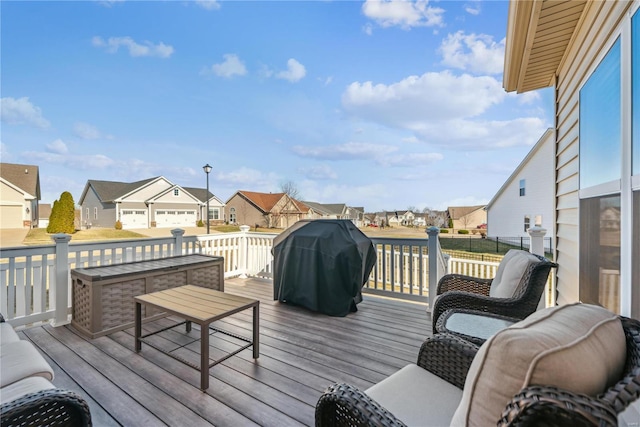 deck with a residential view and a grill