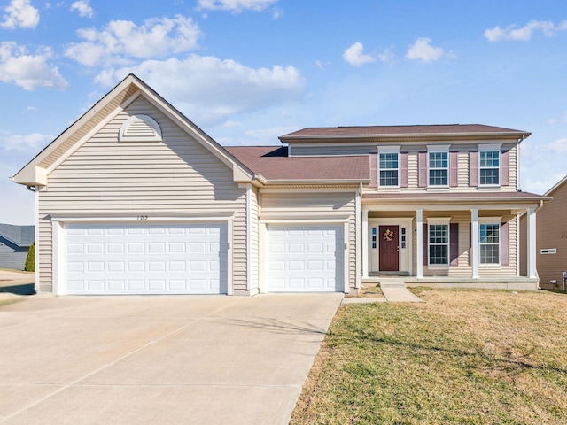 traditional-style house featuring driveway, a porch, an attached garage, and a front yard