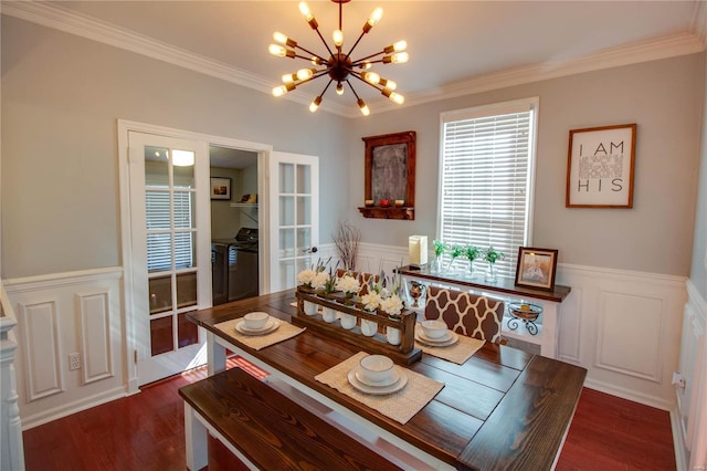 dining room featuring a chandelier, a wainscoted wall, crown molding, and dark wood-style floors