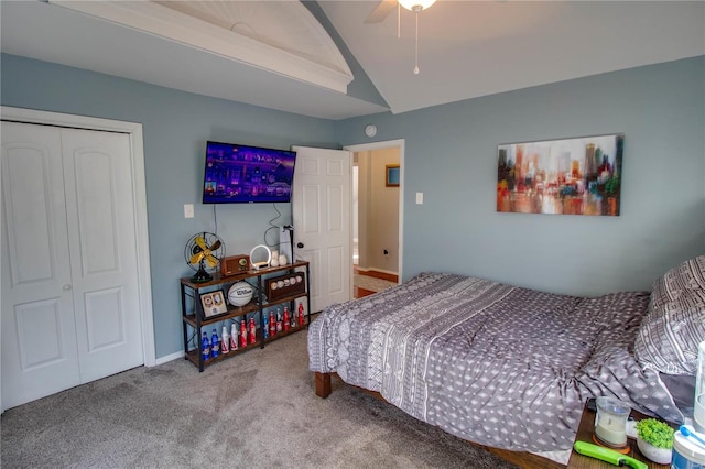 carpeted bedroom featuring vaulted ceiling, ceiling fan, and a closet