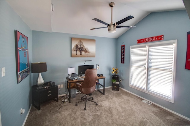 office space featuring a wealth of natural light, visible vents, vaulted ceiling, and carpet flooring