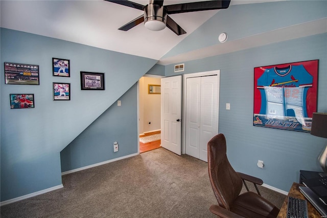 office space featuring ceiling fan, visible vents, vaulted ceiling, and carpet flooring