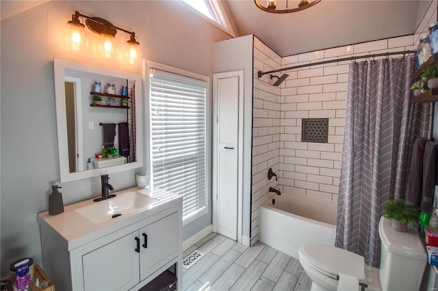 bathroom with toilet, a healthy amount of sunlight, shower / tub combo with curtain, and vanity