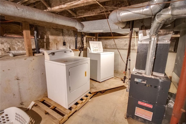 interior space featuring laundry area, washing machine and clothes dryer, and heating unit