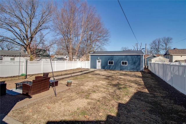 view of yard with an outdoor structure and a fenced backyard