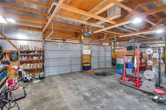 garage featuring metal wall and a garage door opener