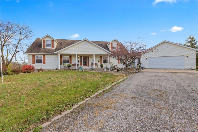 view of front facade featuring a garage, covered porch, driveway, and a front lawn