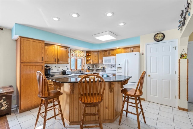 kitchen with a breakfast bar area, open shelves, decorative backsplash, brown cabinetry, and white appliances