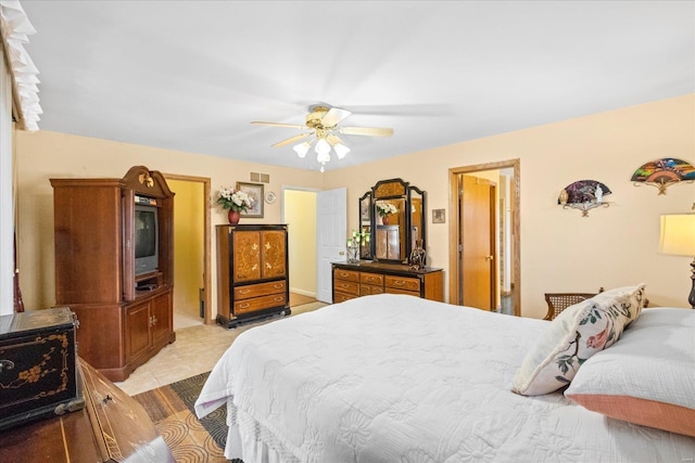 bedroom featuring ceiling fan, light tile patterned floors, and visible vents