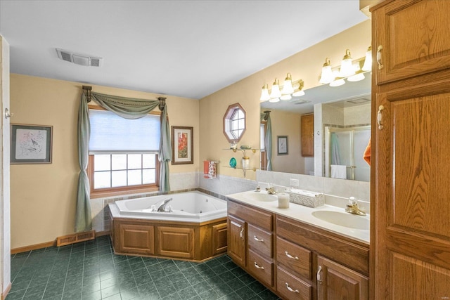 full bathroom with visible vents, a sink, a garden tub, and double vanity