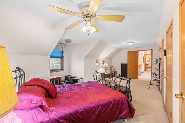 bedroom with lofted ceiling, carpet flooring, and a ceiling fan