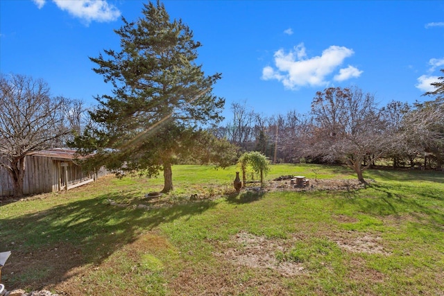 view of yard with an outdoor fire pit