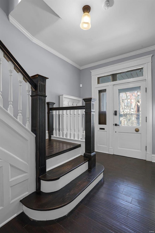 entryway featuring ornamental molding, hardwood / wood-style floors, and stairs