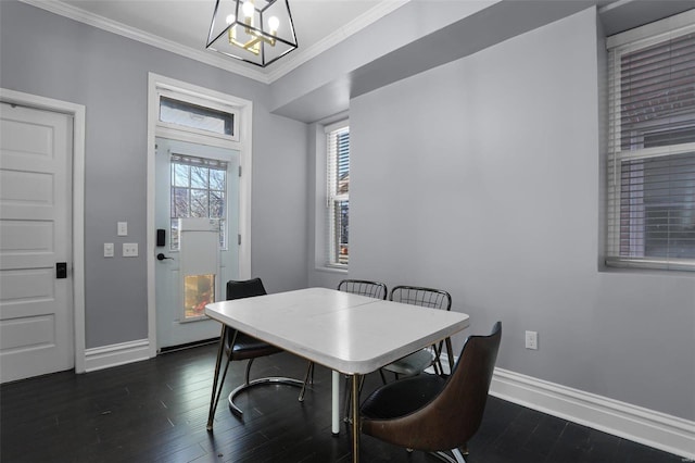 dining space featuring ornamental molding, a notable chandelier, baseboards, and dark wood-style floors