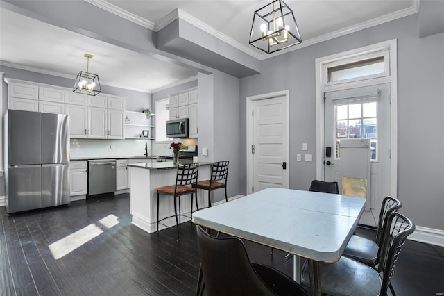 dining room featuring ornamental molding, a chandelier, dark wood finished floors, and baseboards