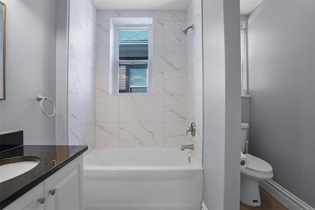 full bathroom featuring toilet, bathing tub / shower combination, vanity, and baseboards