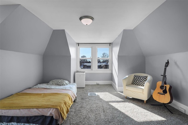 bedroom with vaulted ceiling, carpet floors, and baseboards