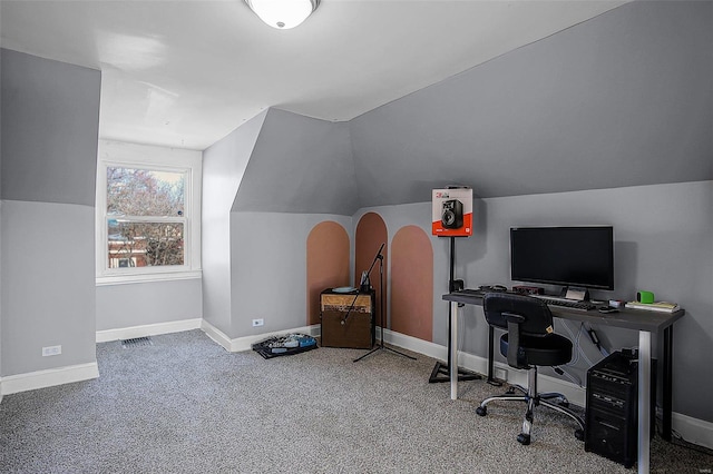 carpeted office with lofted ceiling, visible vents, and baseboards