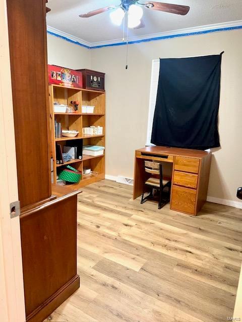 office area featuring ceiling fan, ornamental molding, light wood-style flooring, and baseboards