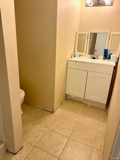 bathroom with vanity, toilet, and tile patterned floors