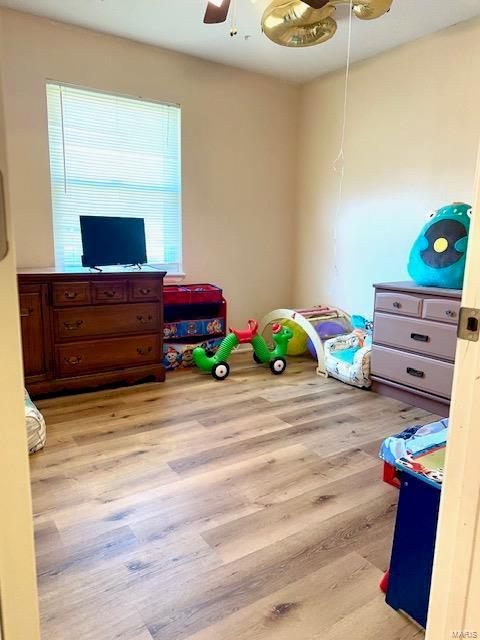 game room with a ceiling fan and wood finished floors