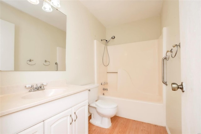 full bathroom with shower / bathtub combination, vanity, toilet, and wood finished floors