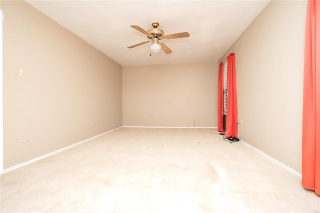 unfurnished room with light carpet, ceiling fan, and baseboards