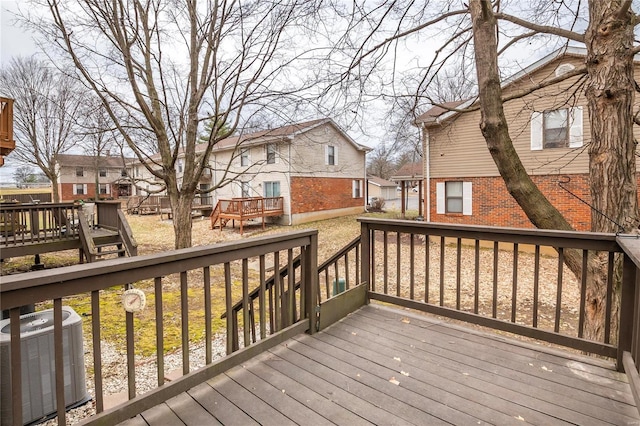 wooden terrace with a residential view and central AC unit