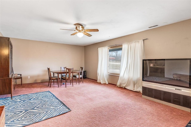 carpeted dining space featuring a ceiling fan and visible vents