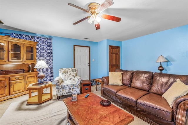 living area featuring ceiling fan and visible vents