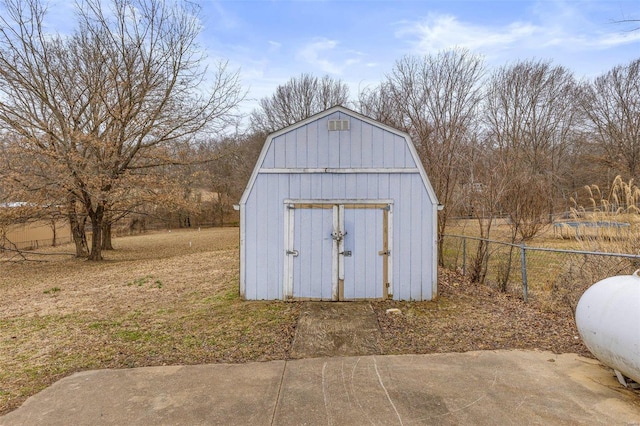 view of shed featuring fence