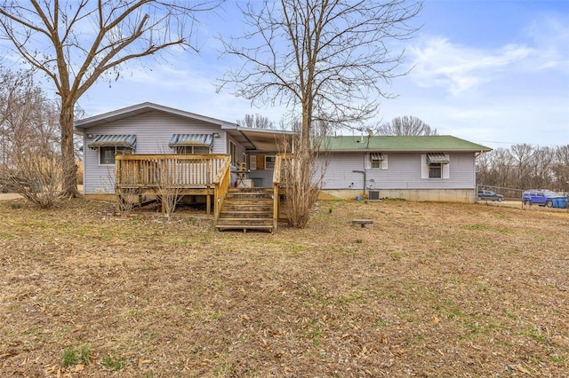 rear view of house featuring a deck and central AC