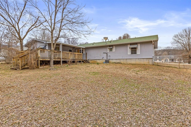 rear view of house featuring a wooden deck