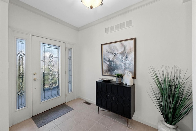 foyer entrance with light tile patterned flooring, visible vents, and ornamental molding