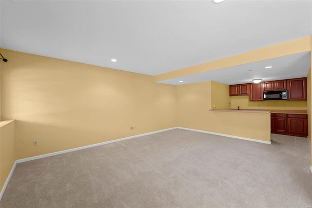 unfurnished living room featuring recessed lighting, light carpet, and baseboards