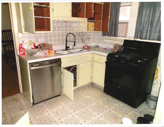 kitchen featuring cream cabinetry, open shelves, light countertops, a sink, and dishwasher