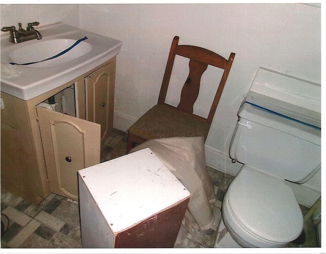 half bath featuring toilet and vanity