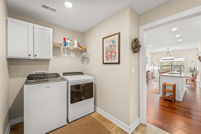 laundry area featuring visible vents, baseboards, cabinet space, recessed lighting, and separate washer and dryer